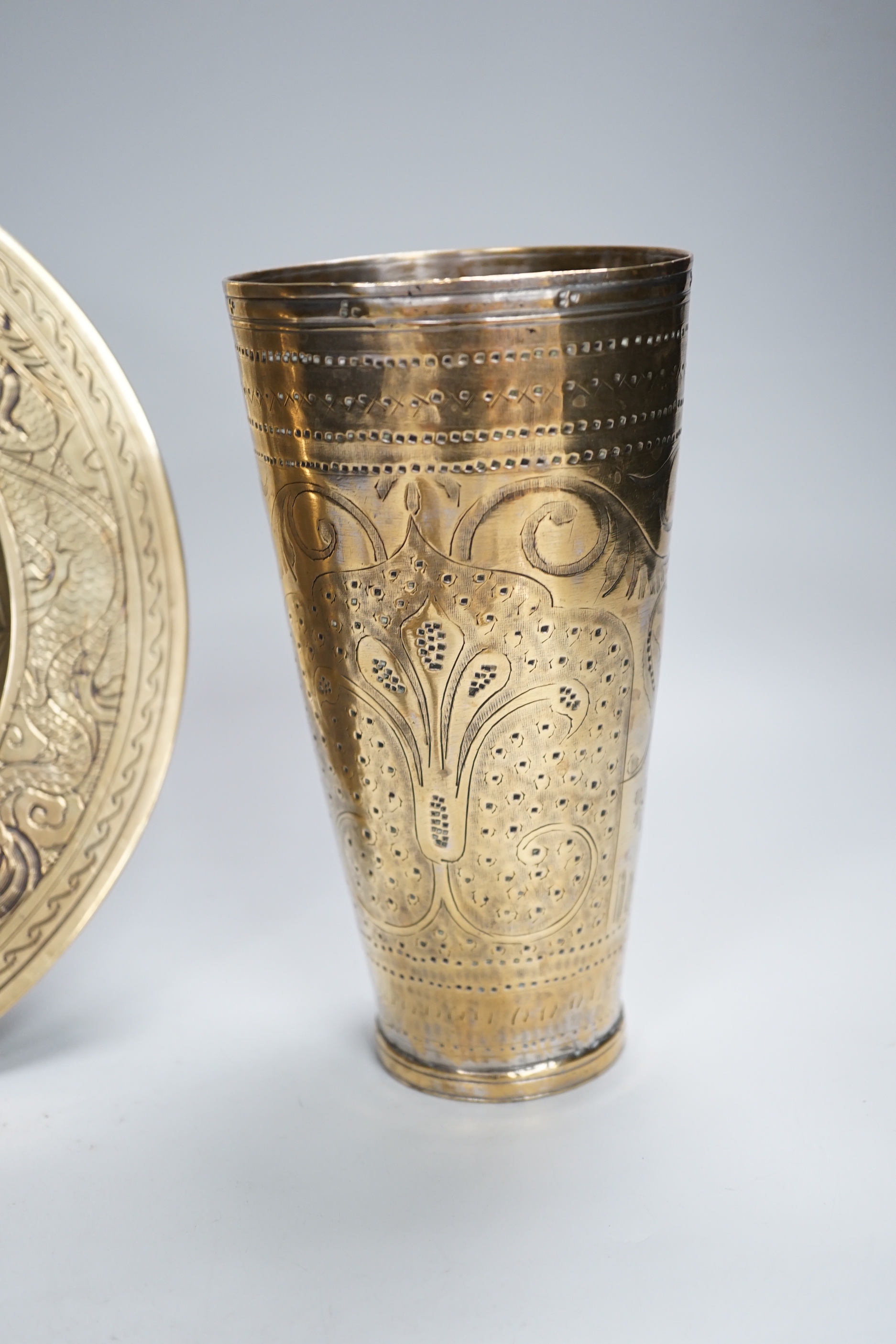 A Chinese engraved brass plate, large engraved beaker, koi fish and a dragon, the largest 24cm in diameter